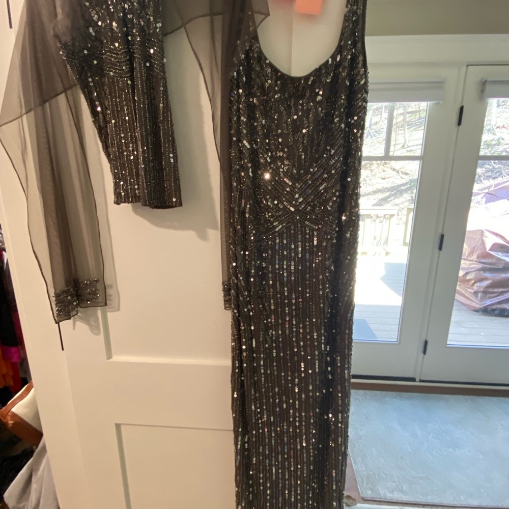 Elegant Sequin Evening Gown with Sheer Sleeves and embellished scarf.